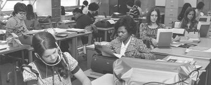 A group of students in a classroom from the early years of the college in black and white